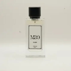 Clear glass perfume bottle labeled Dawn with black cap on a plain light background