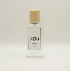 Clear glass perfume bottle with wooden cap labeled 'Desert' against light background